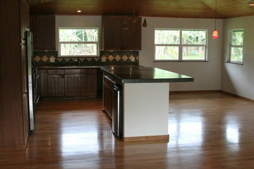 851 Peahi Road Haiku, HI 96708 - Photo 6 of 30 a kitchen with granite countertop a sink cabinets and wooden floor
