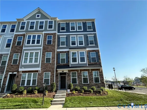 a front view of a residential apartment building with a yard