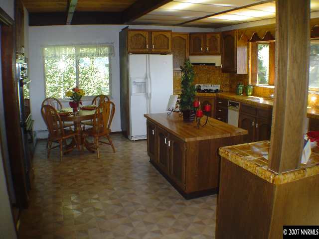 610 Don Drive Zephyr Cove, NV 89448 - Photo 7 of 8 a kitchen with refrigerator and chairs