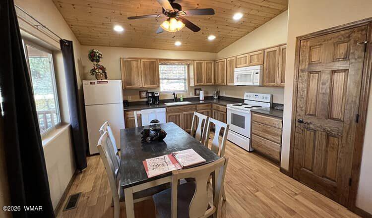 94 Main Street Greer, AZ 85927 - Photo 5 of 10 a kitchen with stainless steel appliances granite countertop a refrigerator stove microwave and sink