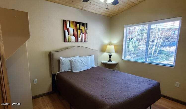 94 Main Street Greer, AZ 85927 - Photo 7 of 10 a bedroom with a bed and a window