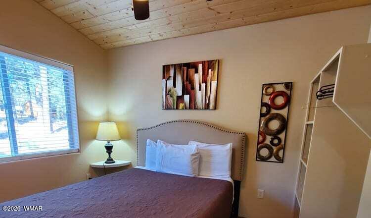 94 Main Street Greer, AZ 85927 - Photo 8 of 10 a bedroom with a bed and window