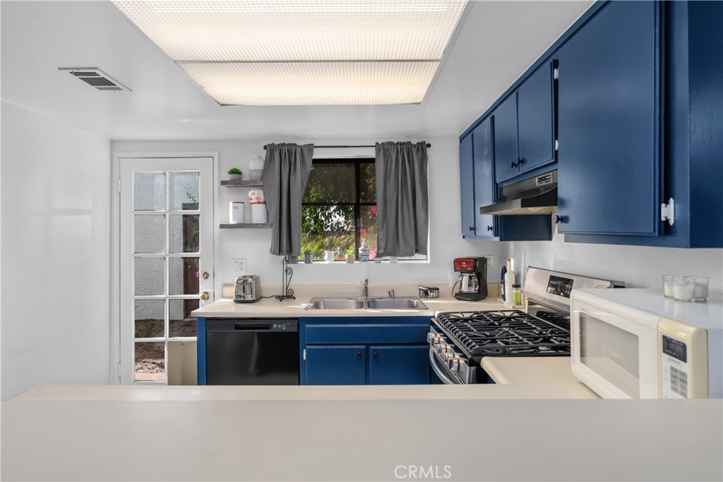 69646 Antonia Way Rancho Mirage, CA 92270 - Photo 25 of 50 a kitchen with a sink and a stove top oven