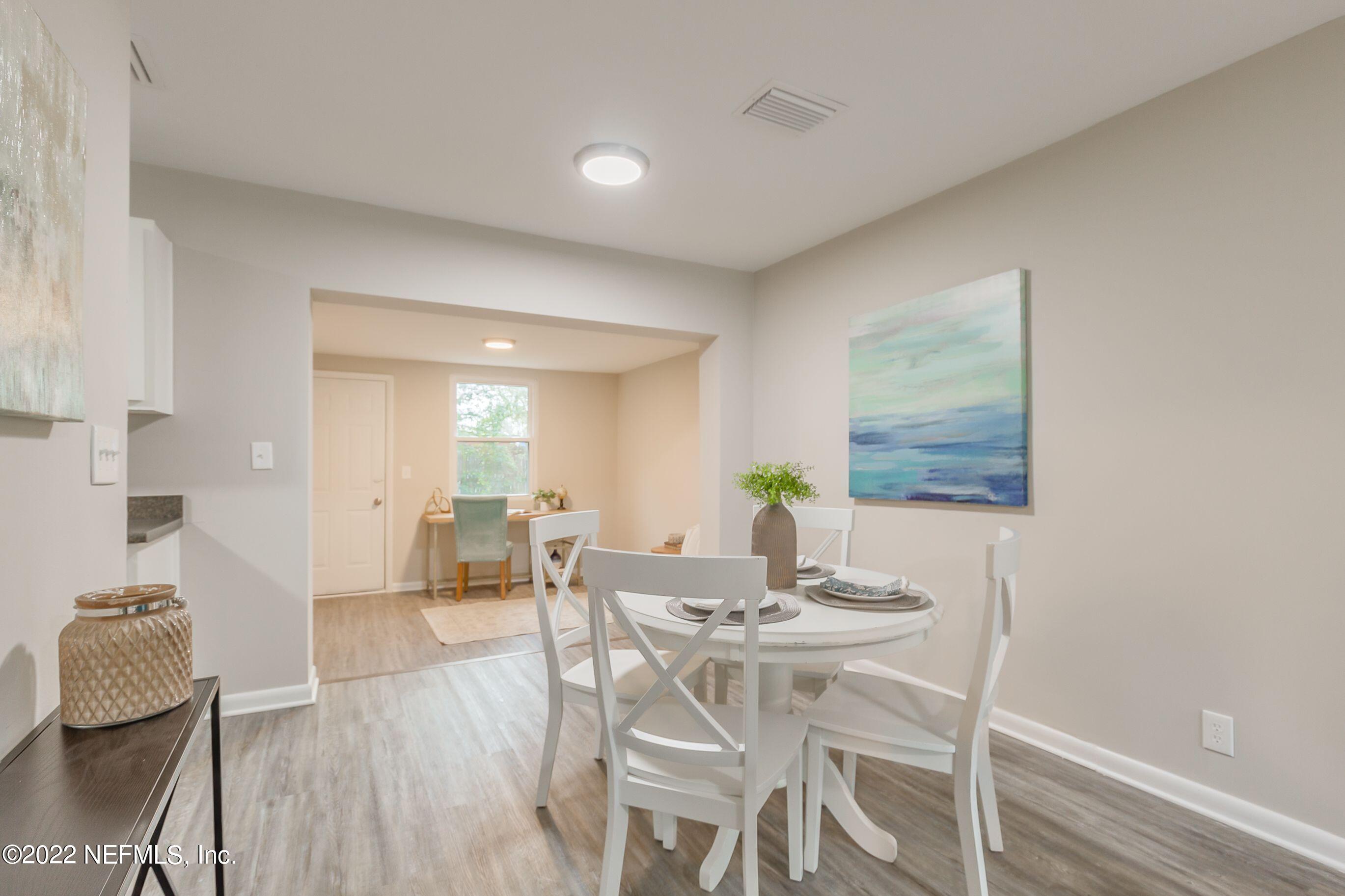 7436 Bamberg Road Jacksonville, FL 32277 - Photo 9 of 28 a view of a dining room with furniture and wooden floor