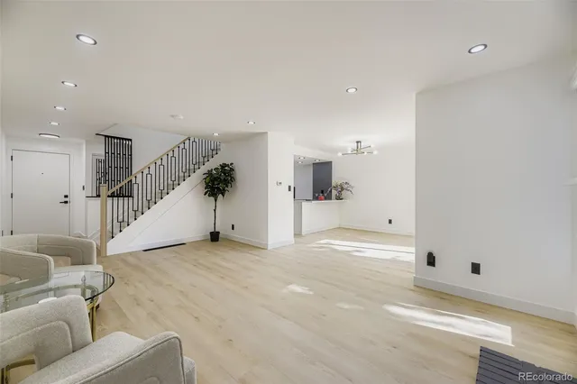 a view of a livingroom with furniture and stairs