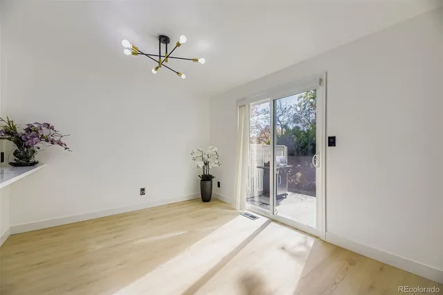 a view of a room with a ceiling fan and window