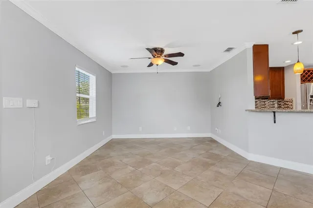 a view of kitchen with refrigerator and window