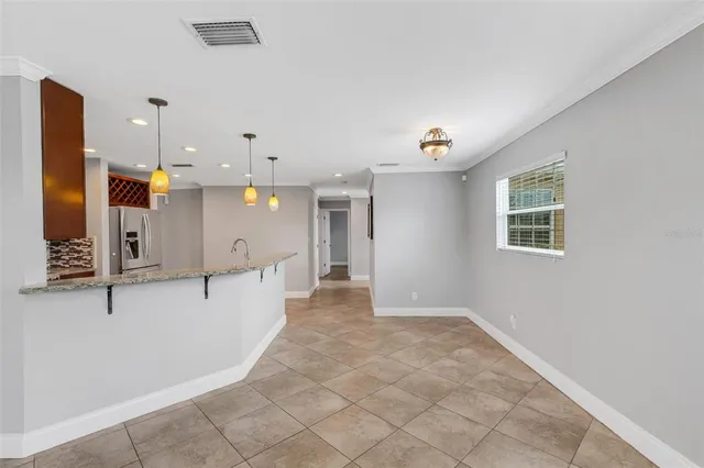a kitchen with granite countertop stainless steel appliances wooden cabinets and a sink