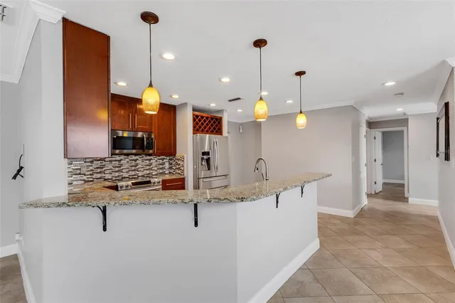 an empty room with ceiling fan and windows