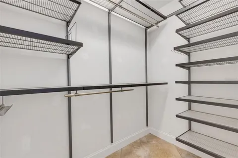 a view of a room with a ceiling fan and window