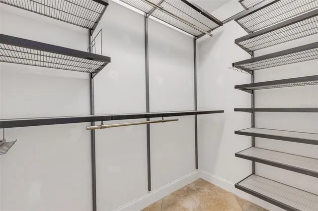 a view of a room with a ceiling fan and window