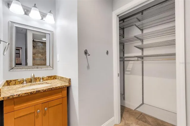 a view of a pathway of a white house with a small yard