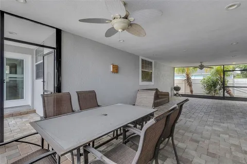 a view of a livingroom with a chandelier fan and closet area