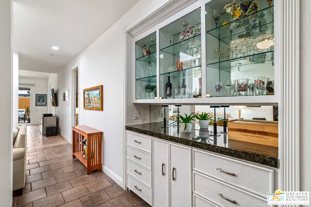 a living room with furniture a rug and a window