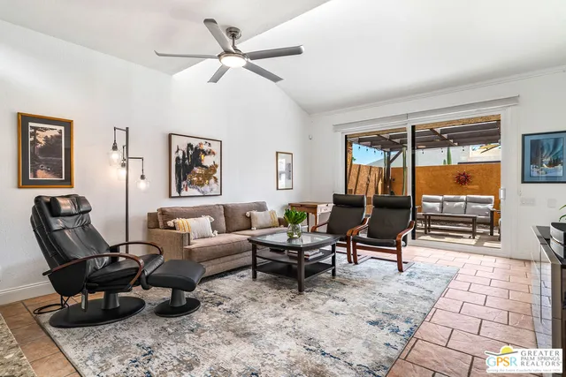 a living room with furniture and a potted plant