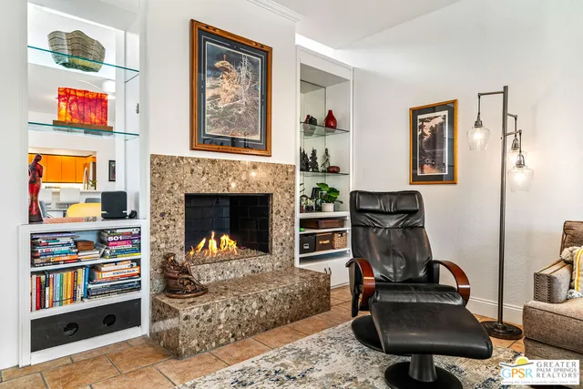 a living room with furniture and a fireplace