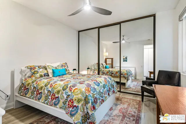 a bathroom with a granite countertop sink mirror vanity and toilet