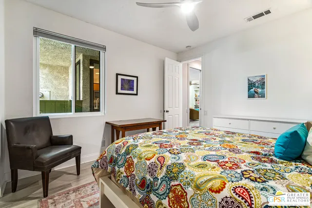 a view of washer and dryer with bathroom in the background