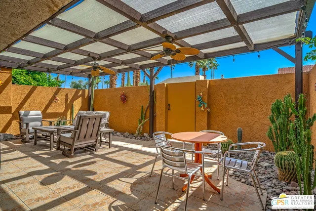 a view of a patio with a dining table and chairs
