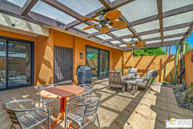 a patio with a table and chairs