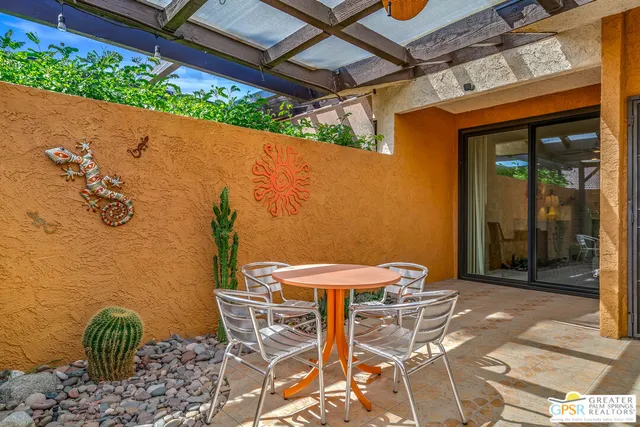 a view of swimming pool with outdoor seating and green space