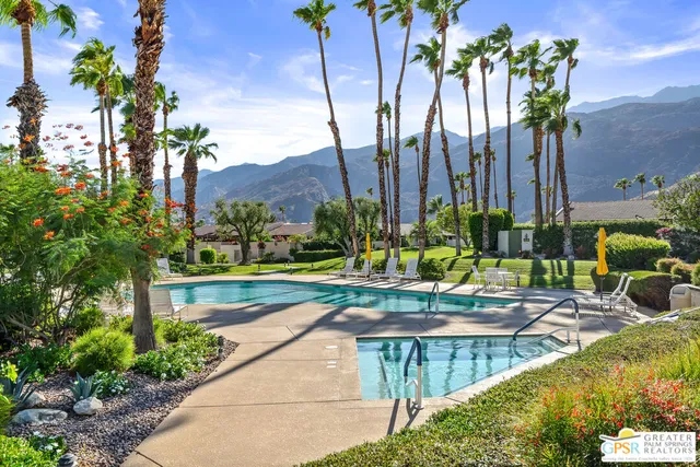 a view of swimming pool with a patio and a yard