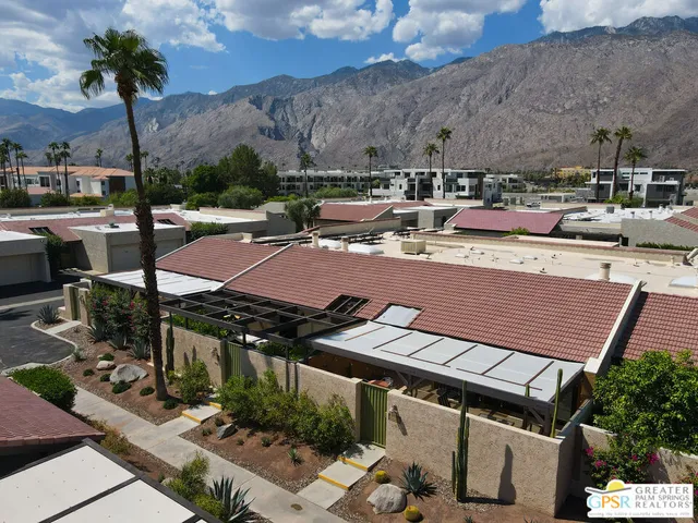an aerial view of a house with a yard and garden