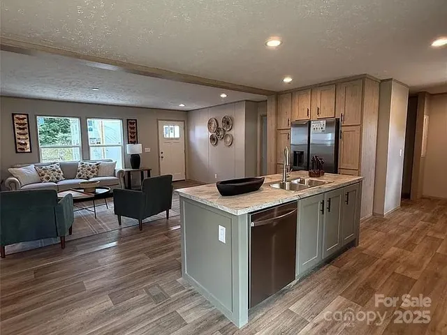 a kitchen with a stove kitchen island furniture and wooden floor