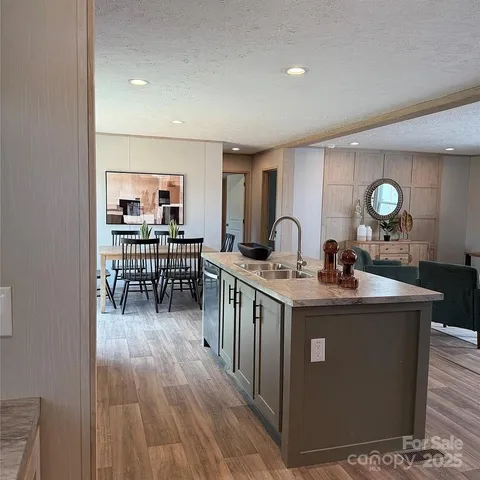 a kitchen with sink stove and cabinets