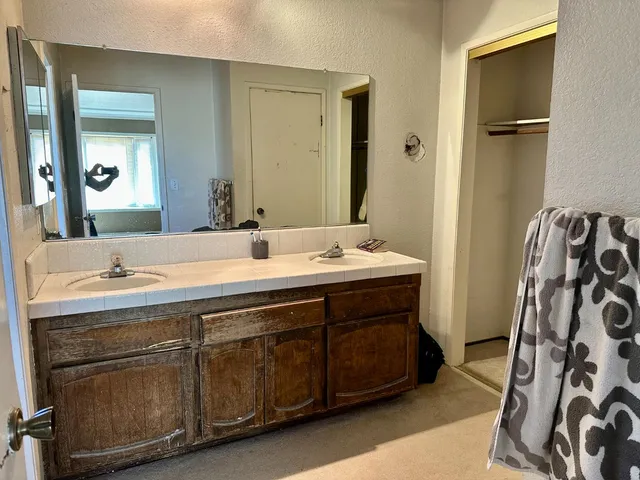 a bathroom with a double vanity sink and a mirror