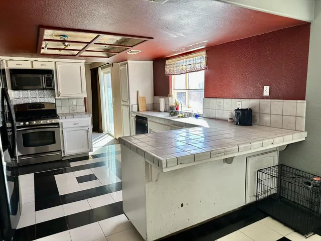 a kitchen with a stove a sink and a refrigerator