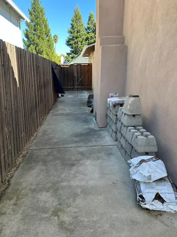 a view of backyard with wooden fence