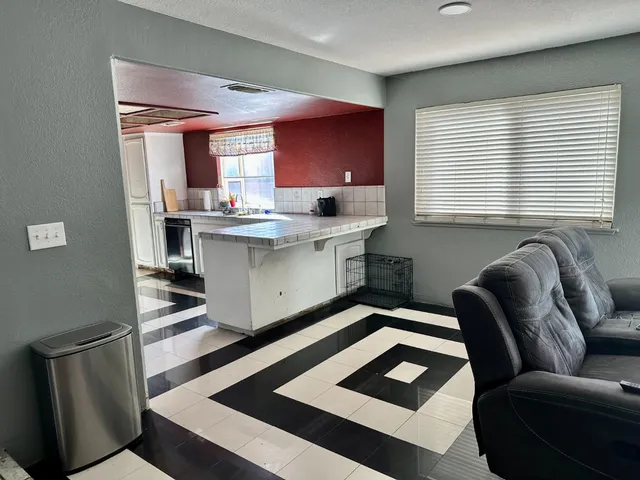 a kitchen with stainless steel appliances granite countertop a sink wooden cabinets and a black granite counter tops