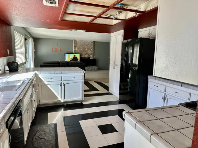 a kitchen with a sink appliances and cabinets