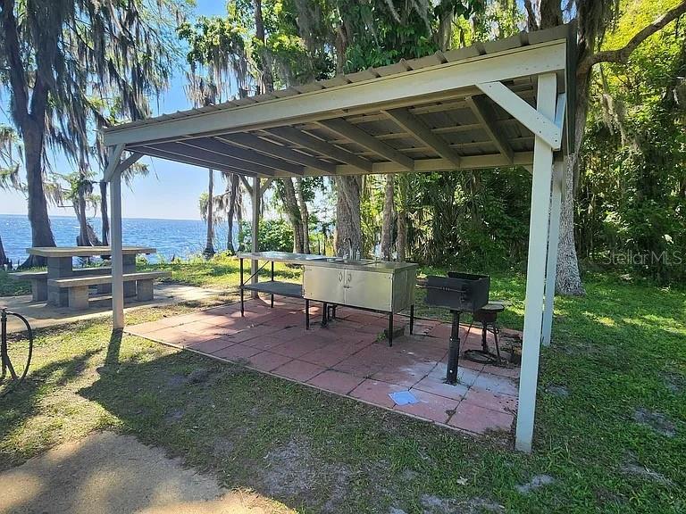 817 Paradise Boulevard Georgetown, FL 32139 - Photo 13 of 14 a view of backyard with table and chairs under an umbrella