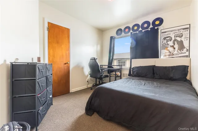 a bed room with a bed and a refrigerator