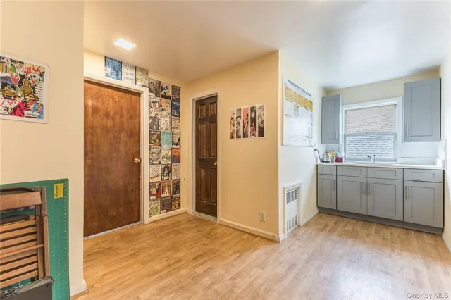 a view of a kitchen with a sink and a refrigerator