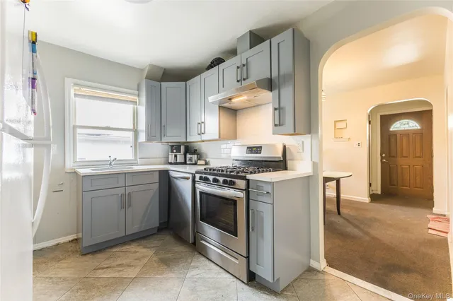 a kitchen with a stove top oven sink and cabinets