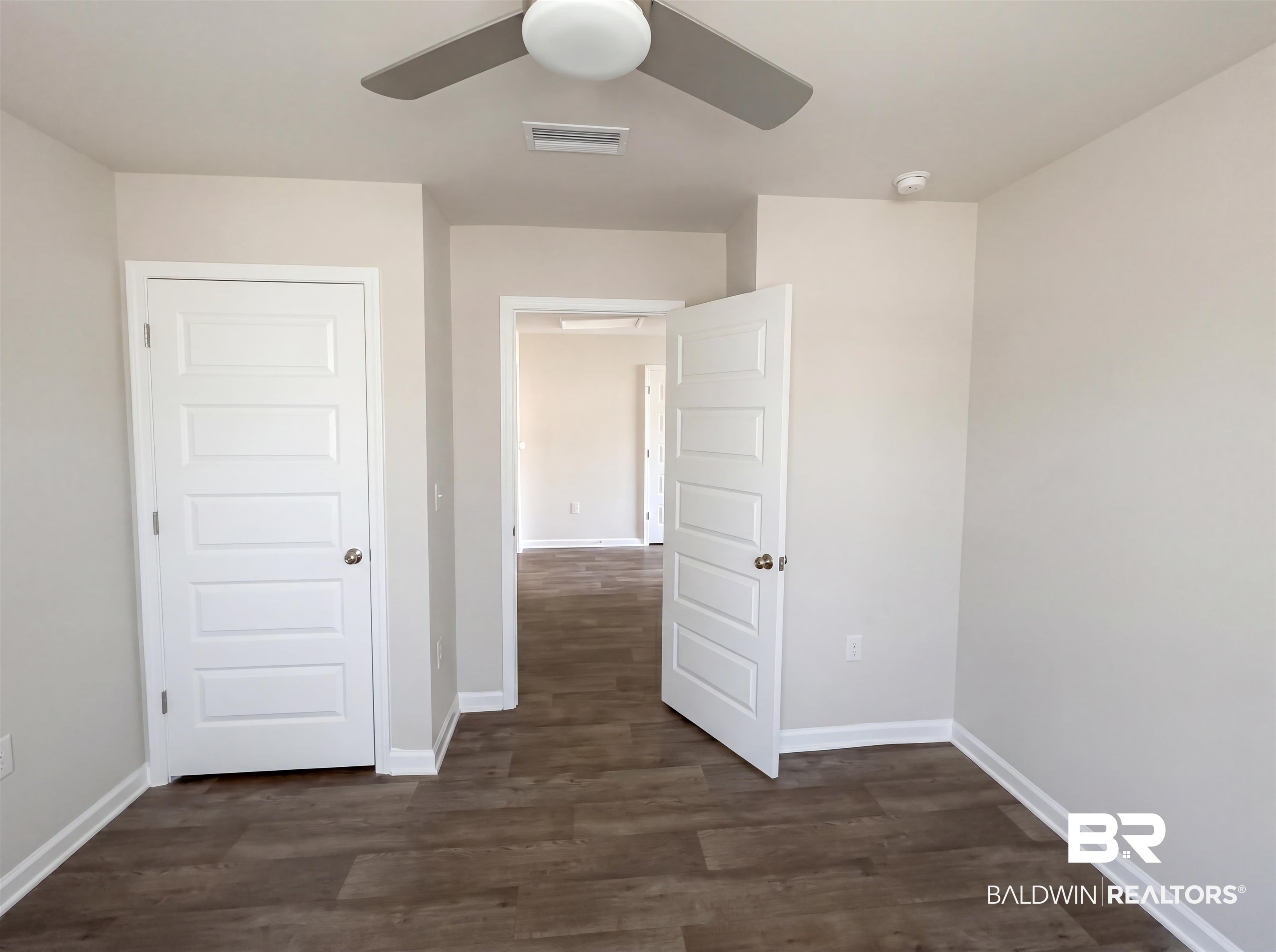 7453 Brompton Drive Foley, AL 36535 - Photo 13 of 15 Interior room featuring wood-finish flooring, white trim, and a ceiling fan