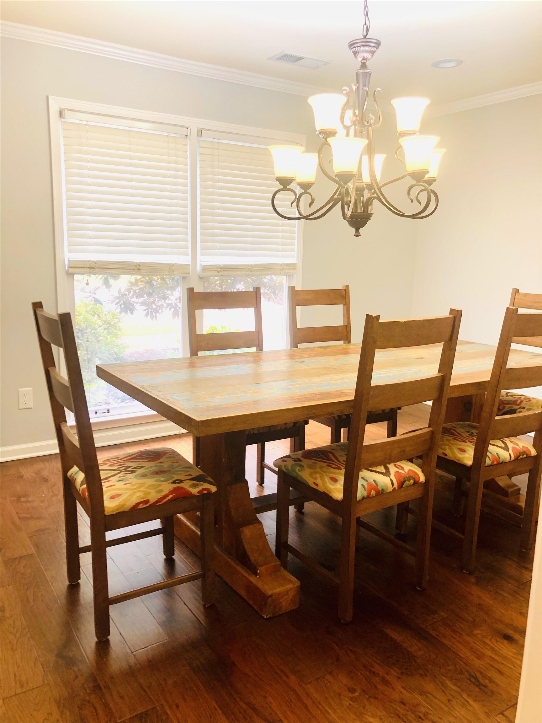 8861 Walnut Ridge Loop Memphis, TN 38018 - Photo 6 of 20 Dining room with hardwood / wood-style flooring, an inviting chandelier, a healthy amount of sunlight, and ornamental molding