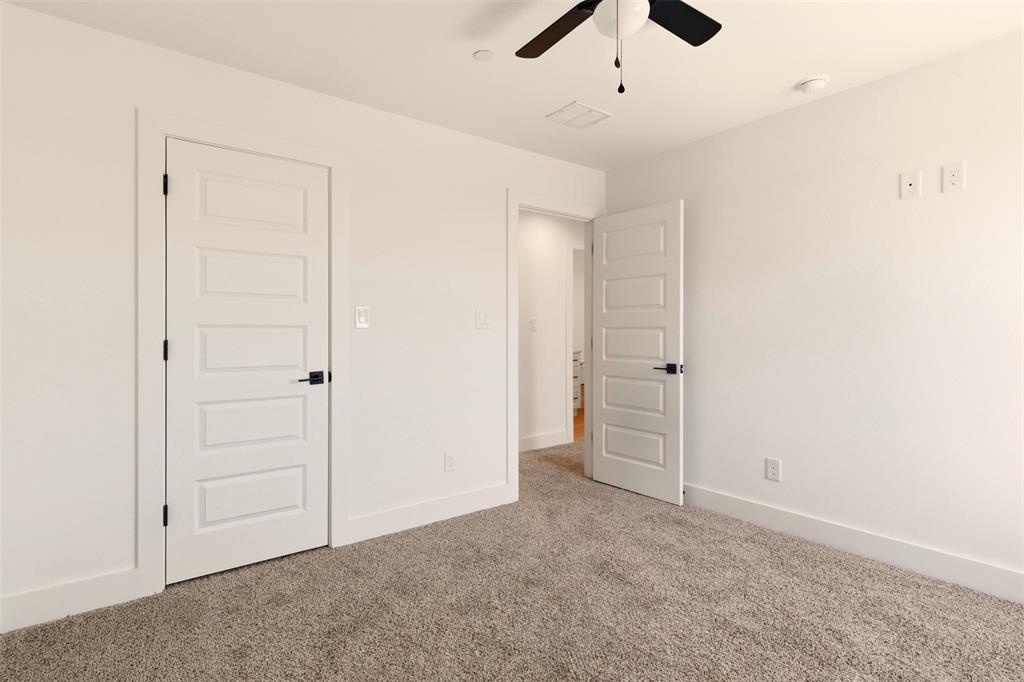 8902 Lowell Street Rowlett, TX 75089 - Photo 17 of 32 an empty room with closet and a ceiling fan