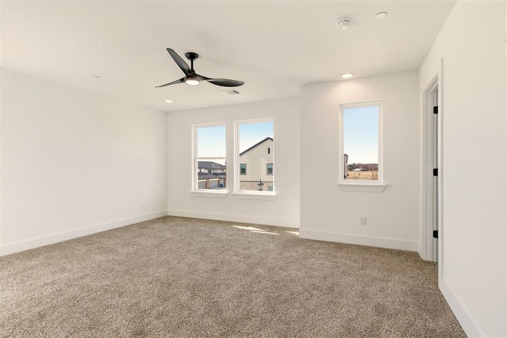 8902 Lowell Street Rowlett, TX 75089 - Photo 19 of 32 an empty room with windows and fan