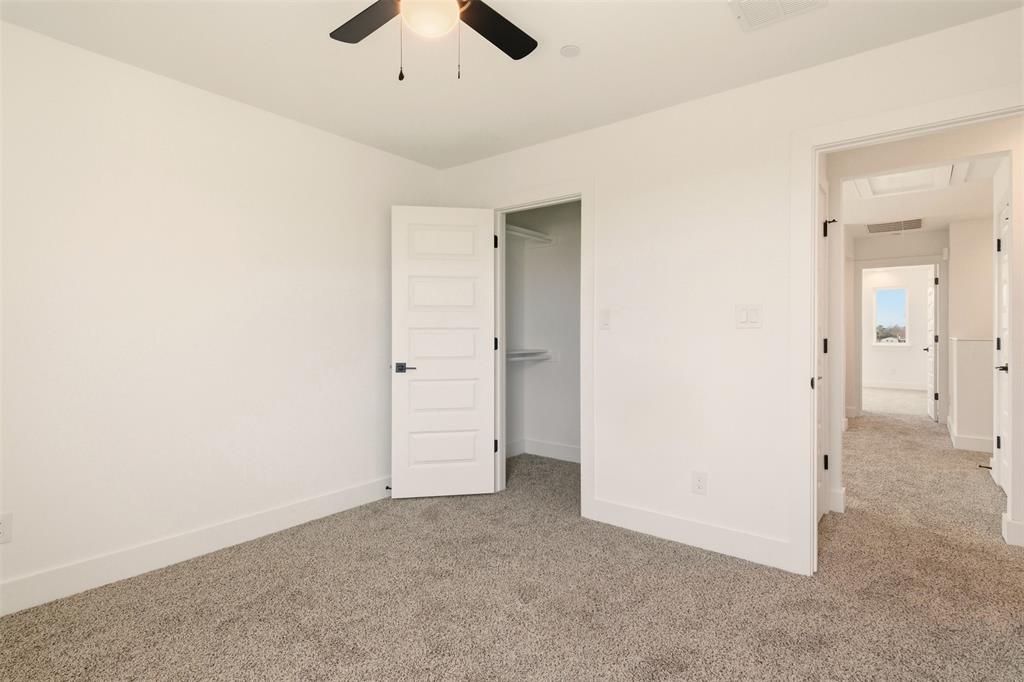 8902 Lowell Street Rowlett, TX 75089 - Photo 23 of 32 an empty room with ceiling fan and entryway