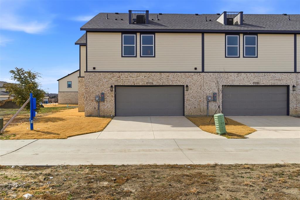 8902 Lowell Street Rowlett, TX 75089 - Photo 28 of 32 a front view of a house with a yard