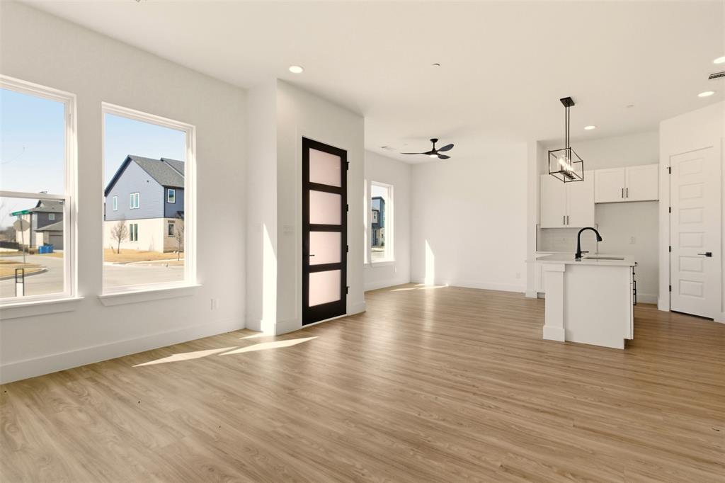 8902 Lowell Street Rowlett, TX 75089 - Photo 4 of 32 a view of empty room with wooden floor and window