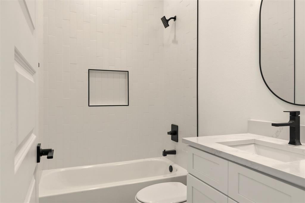8902 Lowell Street Rowlett, TX 75089 - Photo 9 of 32 a bathroom with a sink a toilet and shower