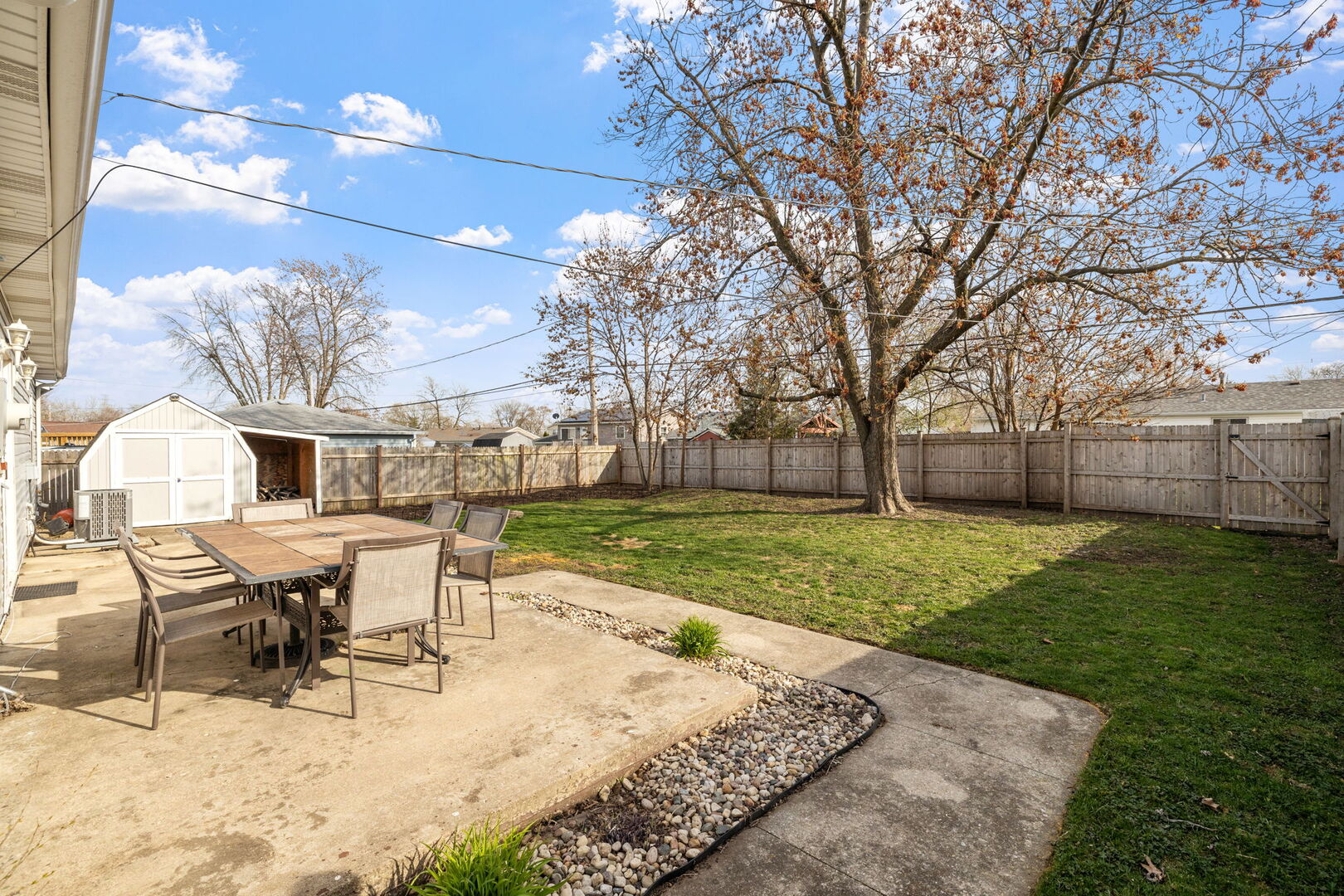 235 Murphy Drive Romeoville, IL 60446 - Photo 14 of 16 a view of a backyard with table and chairs and a slide