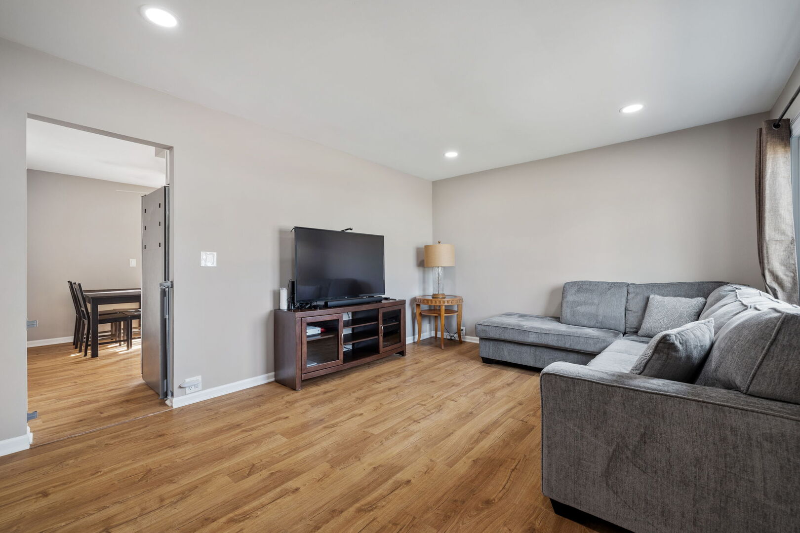 235 Murphy Drive Romeoville, IL 60446 - Photo 2 of 16 a living room with furniture and a flat screen tv