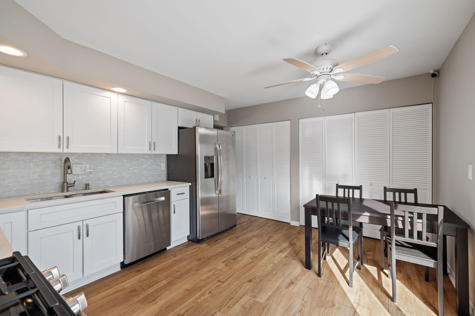 235 Murphy Drive Romeoville, IL 60446 - Photo 7 of 16 a kitchen with stainless steel appliances a table chairs refrigerator and cabinets