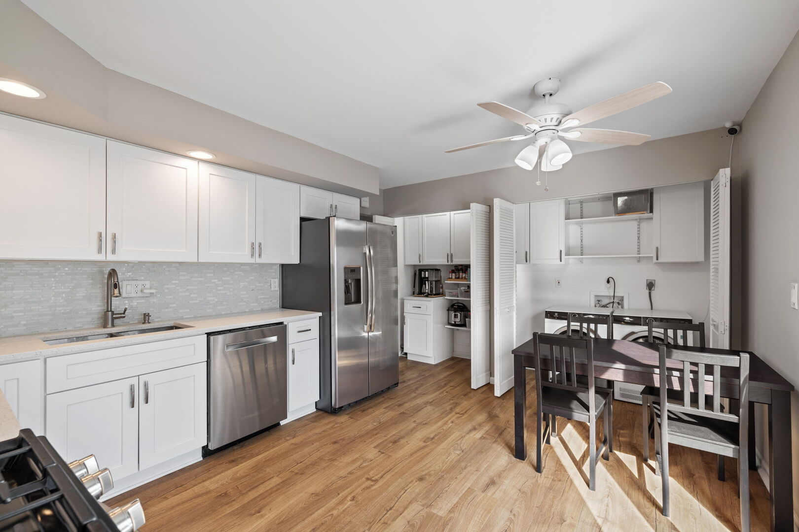 235 Murphy Drive Romeoville, IL 60446 - Photo 8 of 16 a kitchen with stainless steel appliances a stove a sink dishwasher a refrigerator and white cabinets with wooden floor